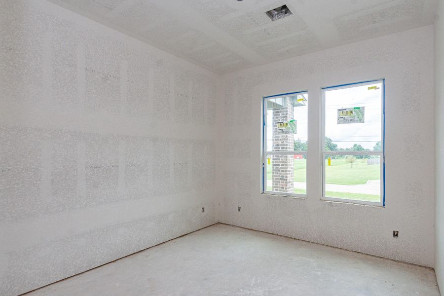 Bright and spacious room with large windows offering views of the lush green landscape outside, perfect for a home office or guest room. Bright and spacious room with large windows offering views of the lush green landscape outside, perfect for a home office or guest room.