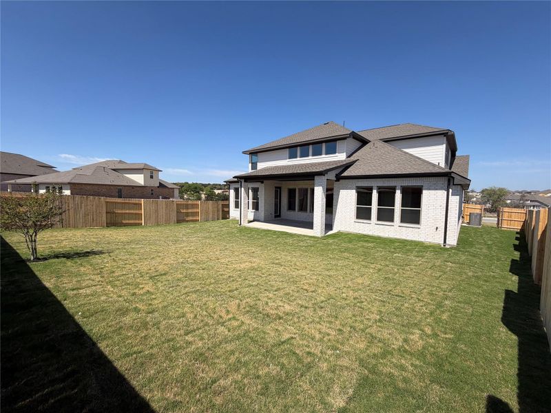 Exterior details and patio area of a home in Lariat, Liberty Hill (Image 18).