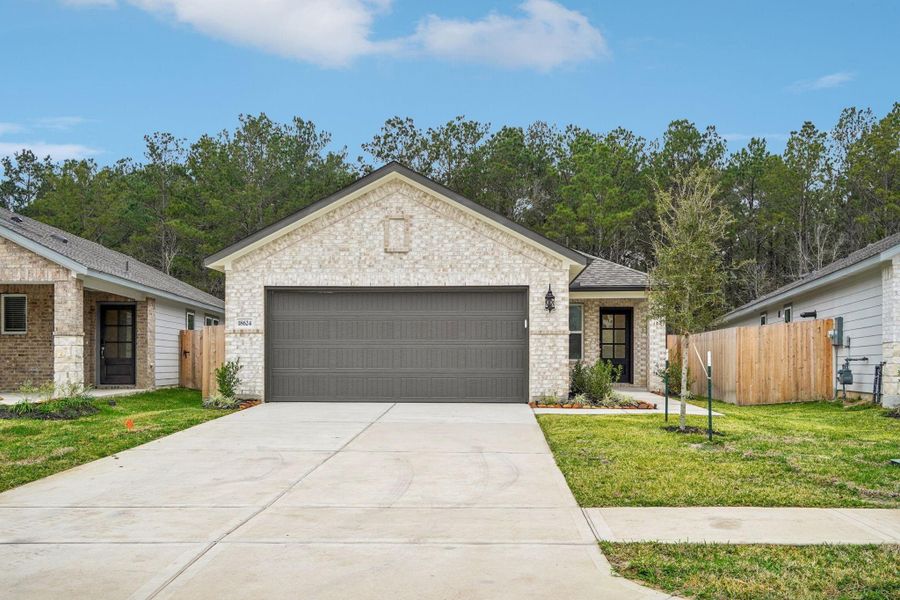 Front exterior of a new home in Landing Meadows - Traditional Series, New Caney, TX, highlighting curb appeal (Image 17).