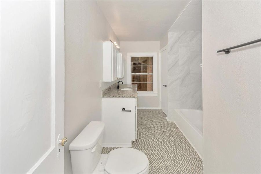 Full bathroom with vanity and tile patterned floors Full bathroom with vanity and tile patterned floors