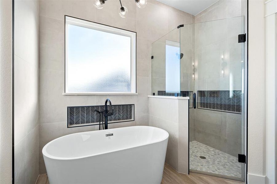 Bathroom featuring wood-type flooring and independent shower and bath