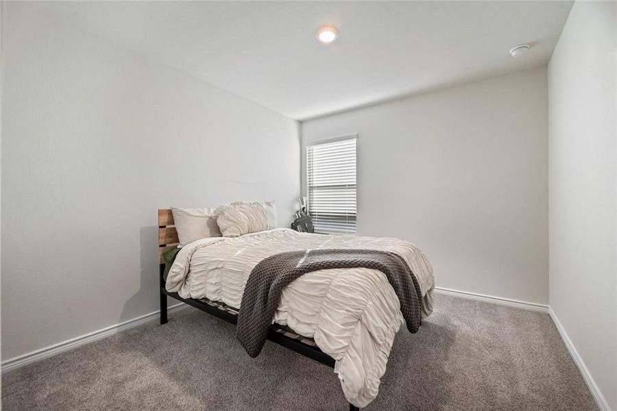 Carpeted bedroom with baseboards