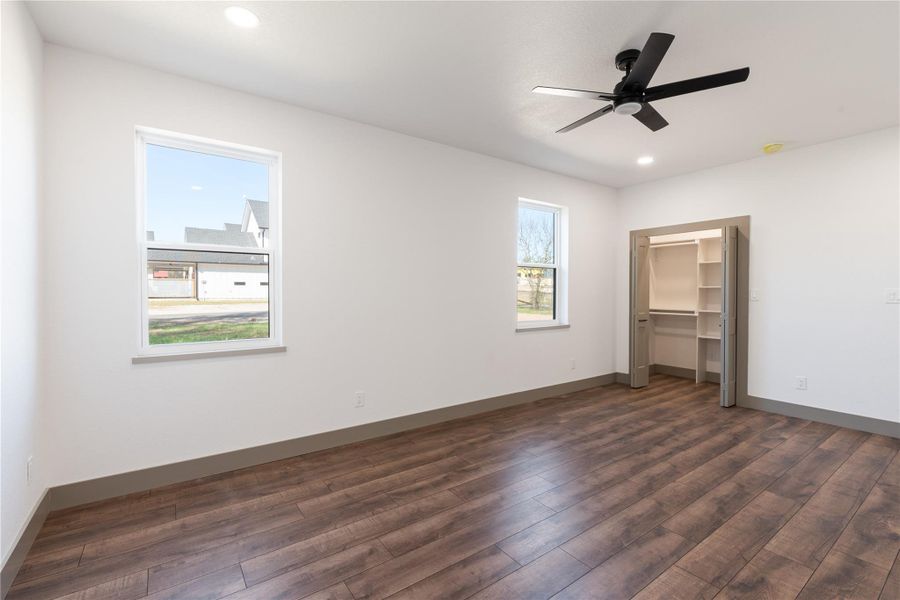Unfurnished bedroom with dark wood-type flooring, recessed lighting, and baseboards