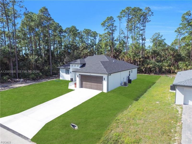 Front exterior of a new home in , Lehigh Acres, FL, highlighting curb appeal (Image 24).