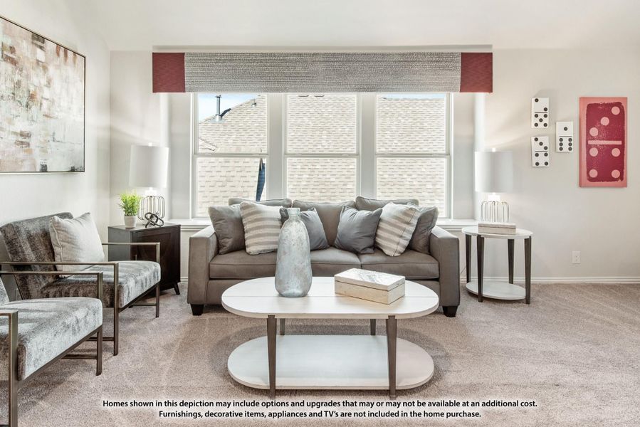 Living room with gray sofa, oval coffee table, carpet flooring, and large window with decorative valance Living room with gray sofa, oval coffee table, carpet flooring, and large window with decorative valance