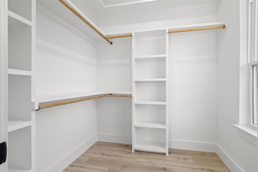 Walk in closet featuring light hardwood / wood-style flooring