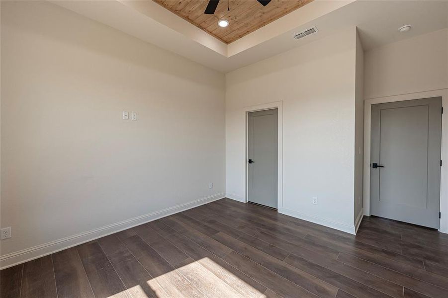 Spare room featuring a ceiling fan, dark wood finished floors, wooden ceiling, a raised ceiling, and recessed lighting Spare room featuring a ceiling fan, dark wood finished floors, wooden ceiling, a raised ceiling, and recessed lighting