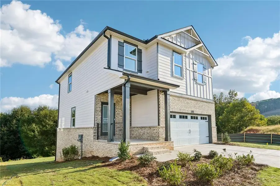 Front exterior of a new home in Hemingway - Reserve Series, Cumming, GA, highlighting curb appeal (Image 1). Front exterior of a new home in Hemingway - Reserve Series, Cumming, GA, highlighting curb appeal (Image 1).