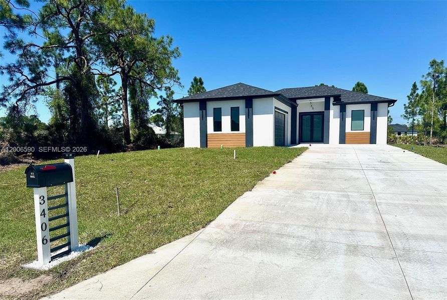 Front exterior of a new home in , Lehigh Acres, FL, highlighting curb appeal (Image 25).