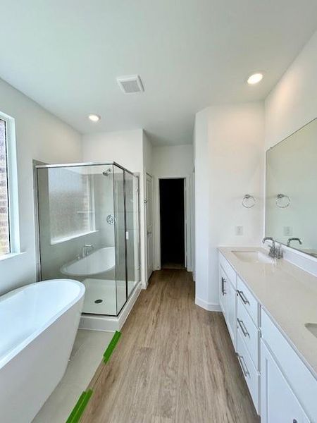 Contemporary bathroom featuring a freestanding soaking tub and a glass-enclosed shower