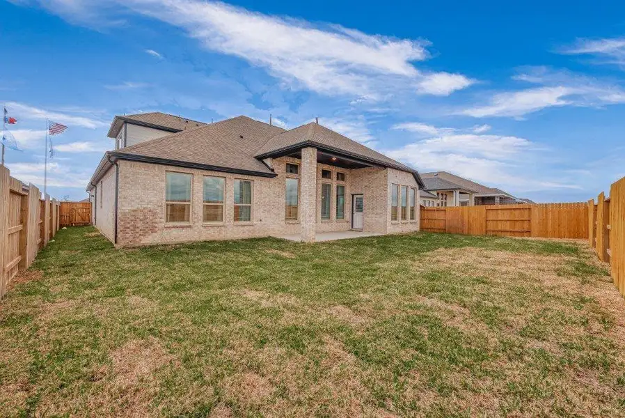Exterior details and patio area of a home in Grand Magnolia, Magnolia (Image 3).