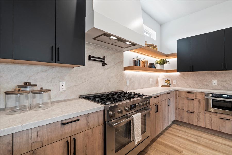 A chef-inspired kitchen featuring premium stainless steel appliances and soft-close drawers and cabinetry for a refined cooking experience. A chef-inspired kitchen featuring premium stainless steel appliances and soft-close drawers and cabinetry for a refined cooking experience.