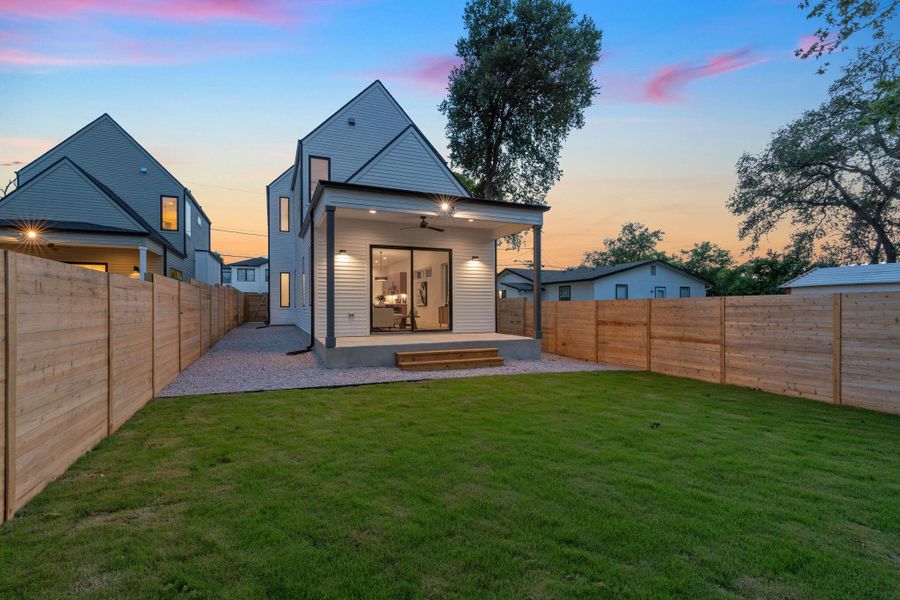 Rear view of house with a ceiling fan, a fenced backyard, and a patio Rear view of house with a ceiling fan, a fenced backyard, and a patio