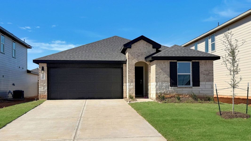 Front exterior of a new home in Tamarron, Fulshear, TX, highlighting curb appeal (Image 1). Front exterior of a new home in Tamarron, Fulshear, TX, highlighting curb appeal (Image 1).