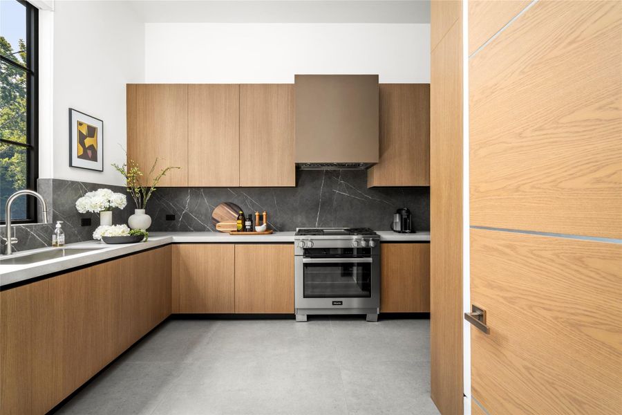 [Prep Kitchen/Scullery] Miele 36" range with dual stacked burners and Miele fridge. Extra storage throughout.