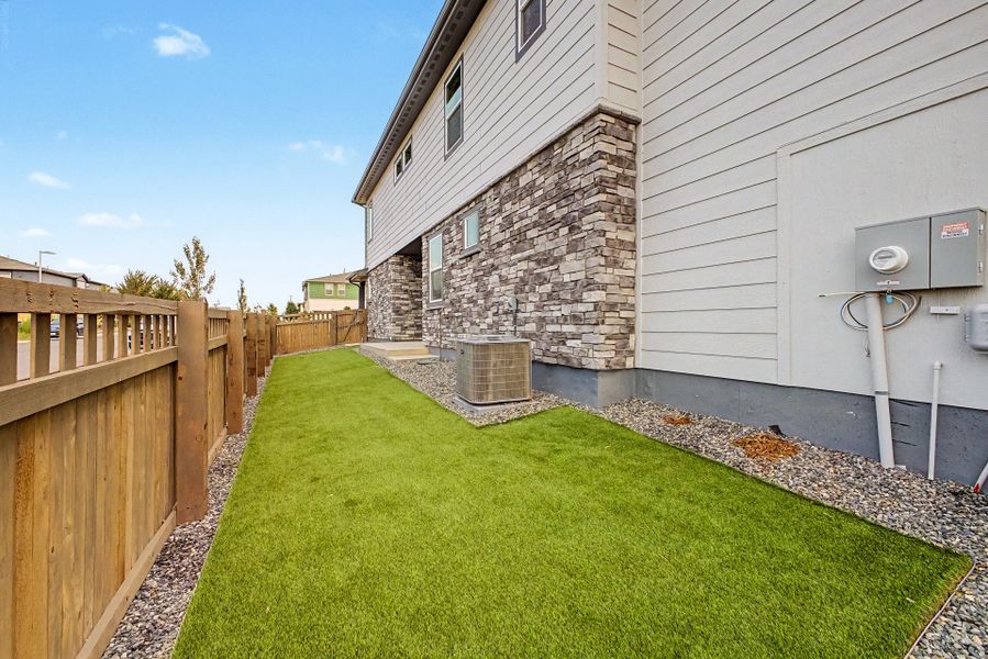 Exterior details and patio area of a home in Painted Prairie, Aurora (Image 14).