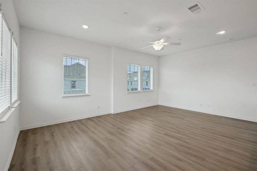 Empty room featuring ceiling fan and light hardwood / wood-style floors