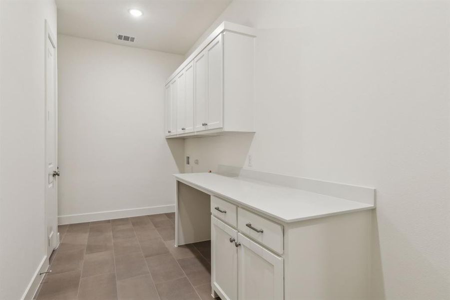 Full bathroom featuring tile patterned flooring, vanity, toilet, and tiled shower / bath