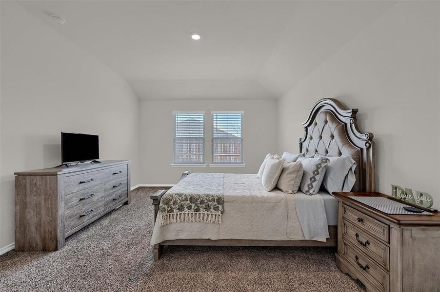 Bedroom featuring baseboards, lofted ceiling, carpet floors, and recessed lighting