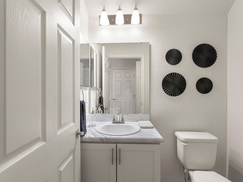 And, a downstairs powder room serves your guests - Flora townhome by Highland Homes