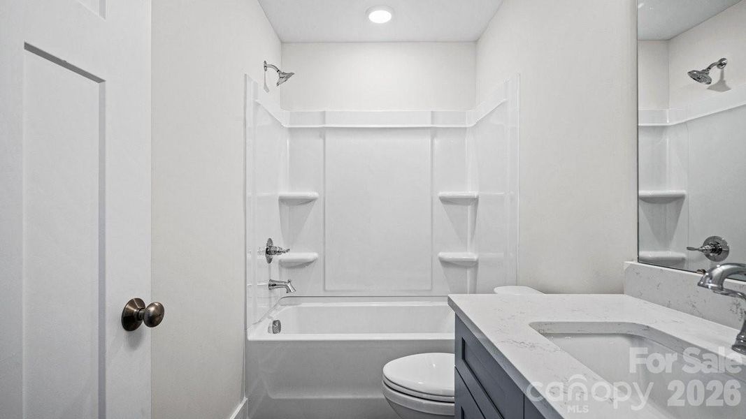 Guest Bath, Quartz Tops, Tile Flooring.
