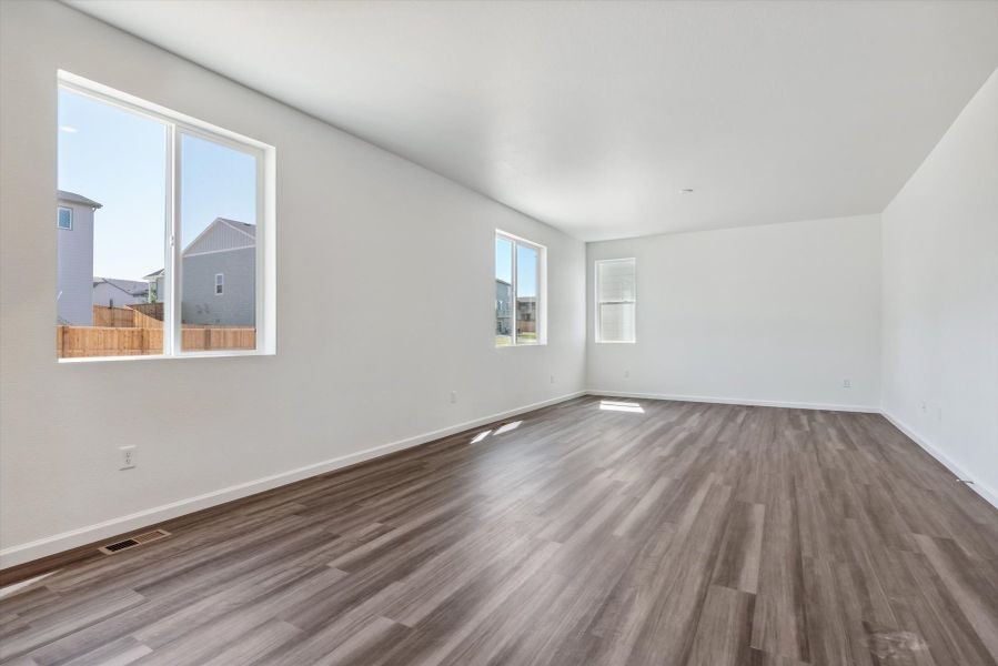 A room with a wood floor and windows.