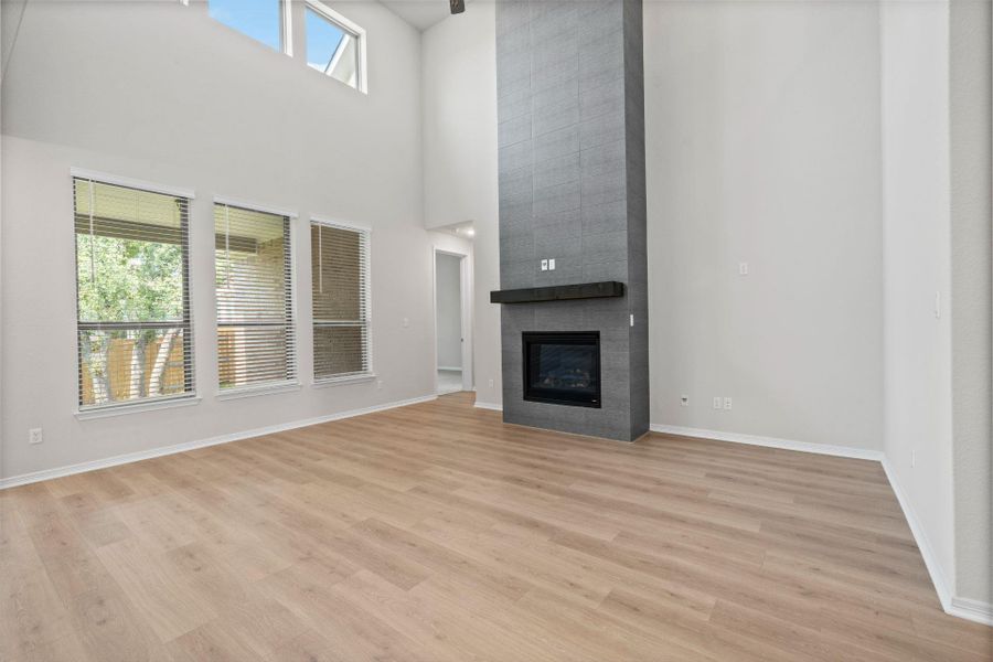 Family Room with soaring ceiling & fireplace