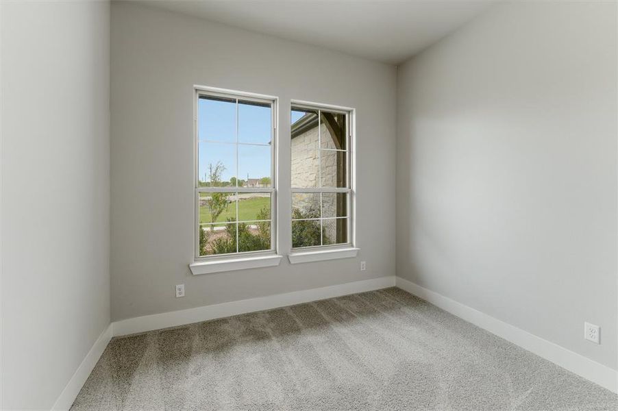 Unfurnished room with light carpet and baseboards