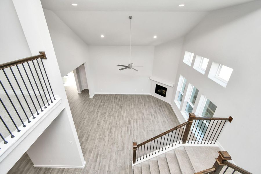 View from above looking at the expansive open family room. Sample photo of completed home with similar floor plan. As-built interior colors and selections may vary.