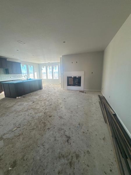 Unfurnished living room featuring a glass covered fireplace Unfurnished living room featuring a glass covered fireplace