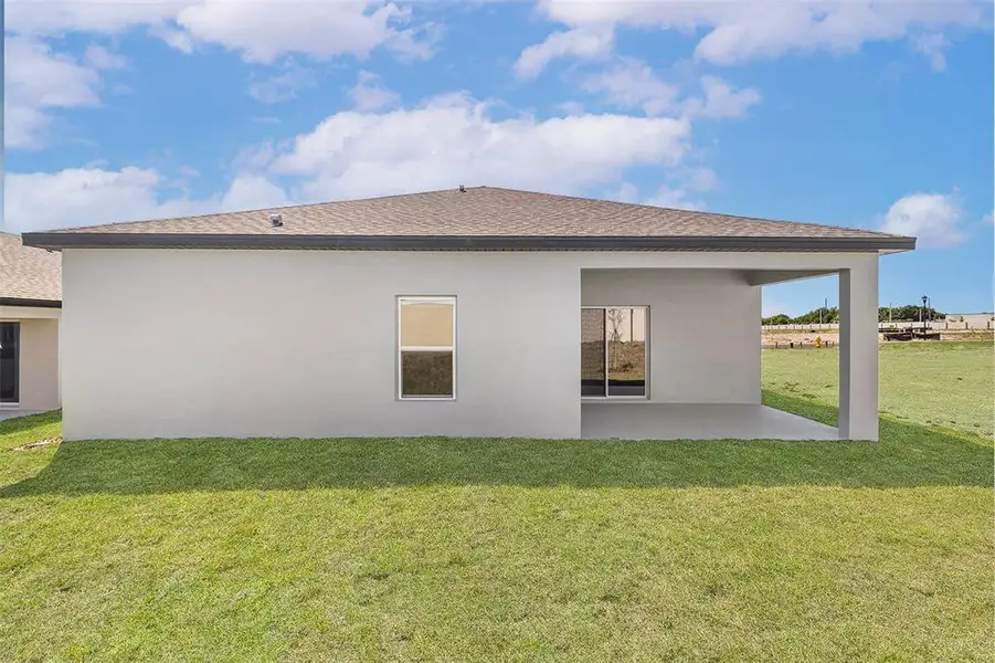 Exterior details and patio area of a home in Peach Crossings, Winter Haven (Image 3).