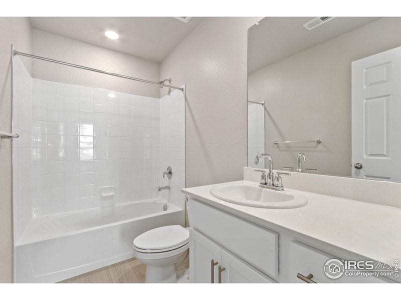 2nd bath with tile tub and shower.