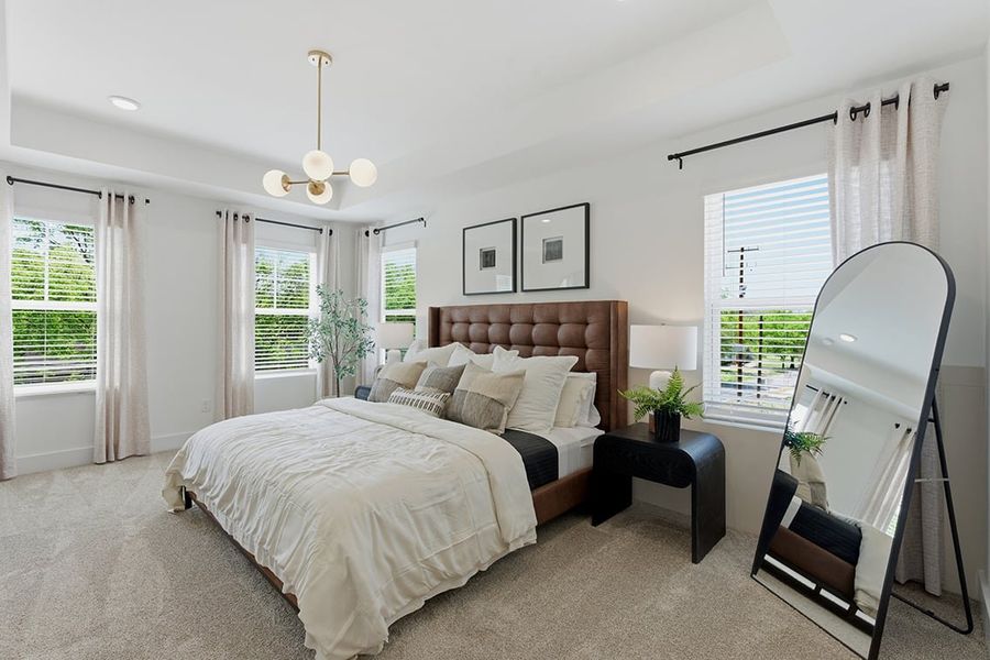 A bedroom with a large mirror.