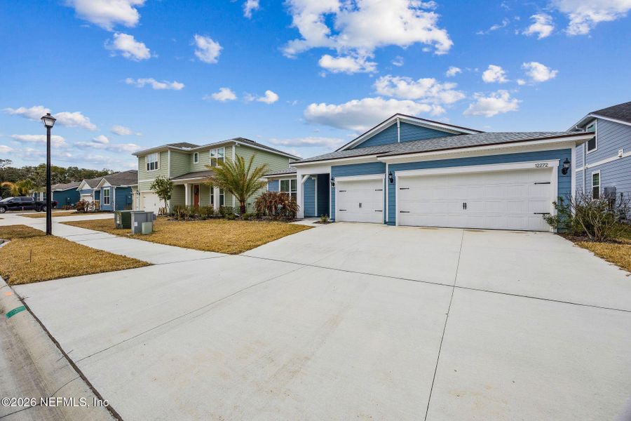 Front exterior of a new home in Wingate Landing, Jacksonville, FL, highlighting curb appeal (Image 27).
