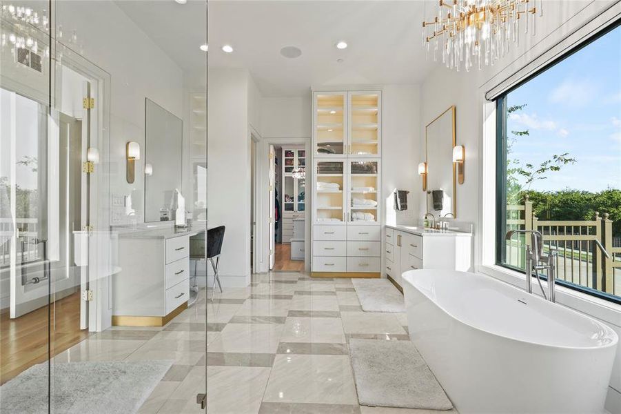 Bathroom with vanity, a spacious closet, a freestanding bath, recessed lighting, and light tile patterned floors Bathroom with vanity, a spacious closet, a freestanding bath, recessed lighting, and light tile patterned floors