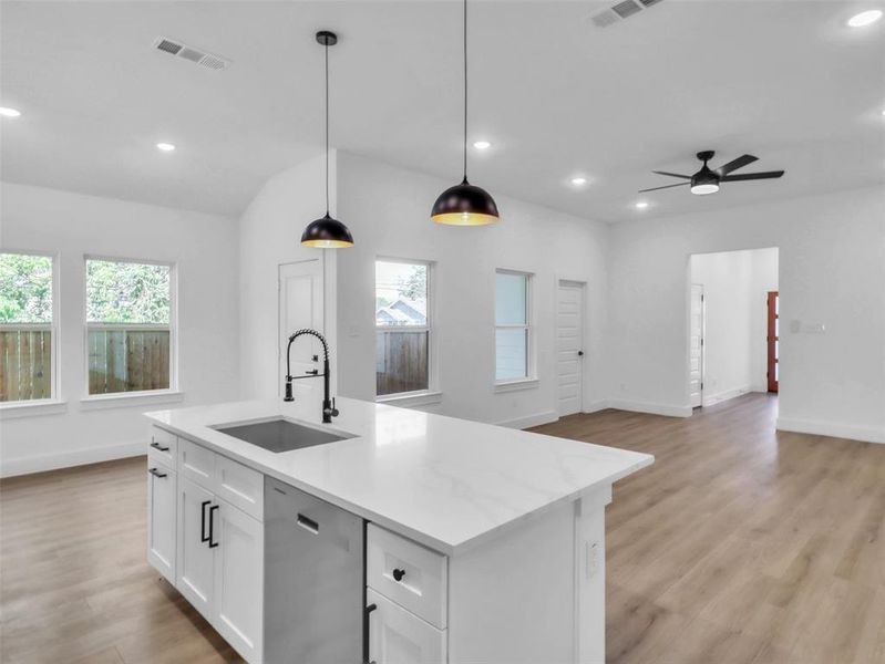 Kitchen with plenty of natural light, dishwasher, visible vents, and a sink Kitchen with plenty of natural light, dishwasher, visible vents, and a sink