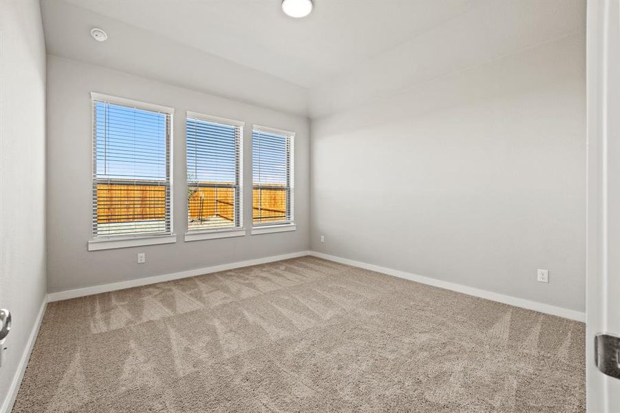 Empty room featuring light carpet