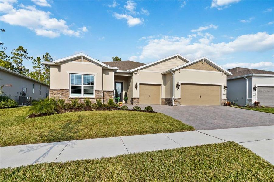 Front exterior of a new home in Del Webb Sunbridge, St. Cloud, FL, highlighting curb appeal (Image 27).