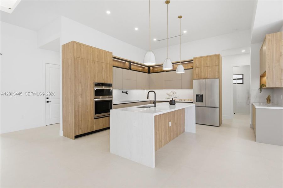 Chef-inspired gourmet kitchen showcasing sleek European-style custom cabinetry, Taj-Mahal inspired quartz countertops w/ waterfall island Chef-inspired gourmet kitchen showcasing sleek European-style custom cabinetry, Taj-Mahal inspired quartz countertops w/ waterfall island
