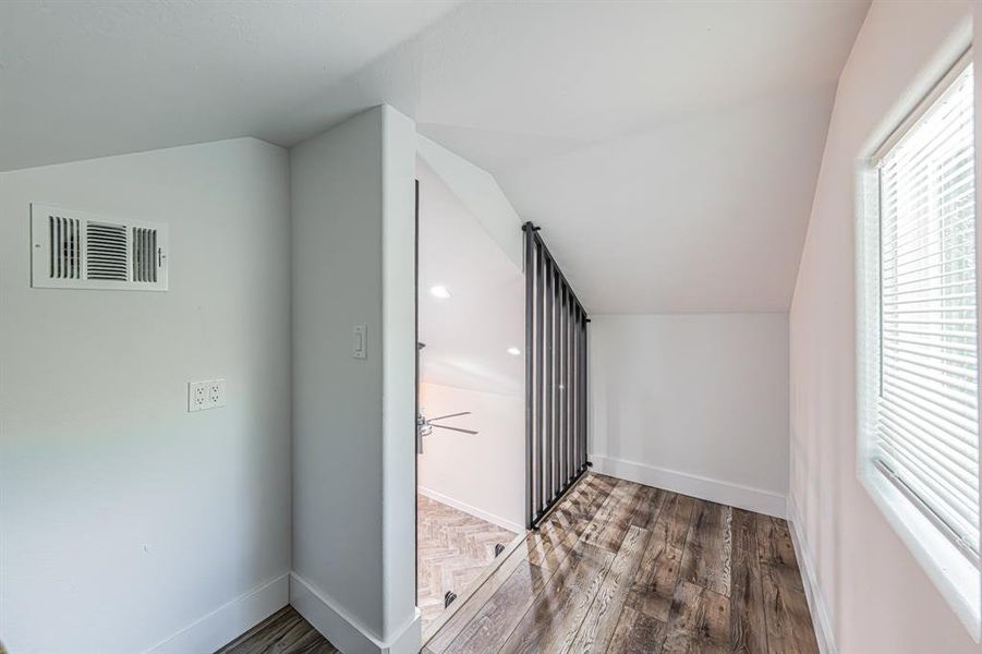 Bonus room with vaulted ceiling, healthy amount of natural light, dark wood-type flooring, and recessed lighting Bonus room with vaulted ceiling, healthy amount of natural light, dark wood-type flooring, and recessed lighting