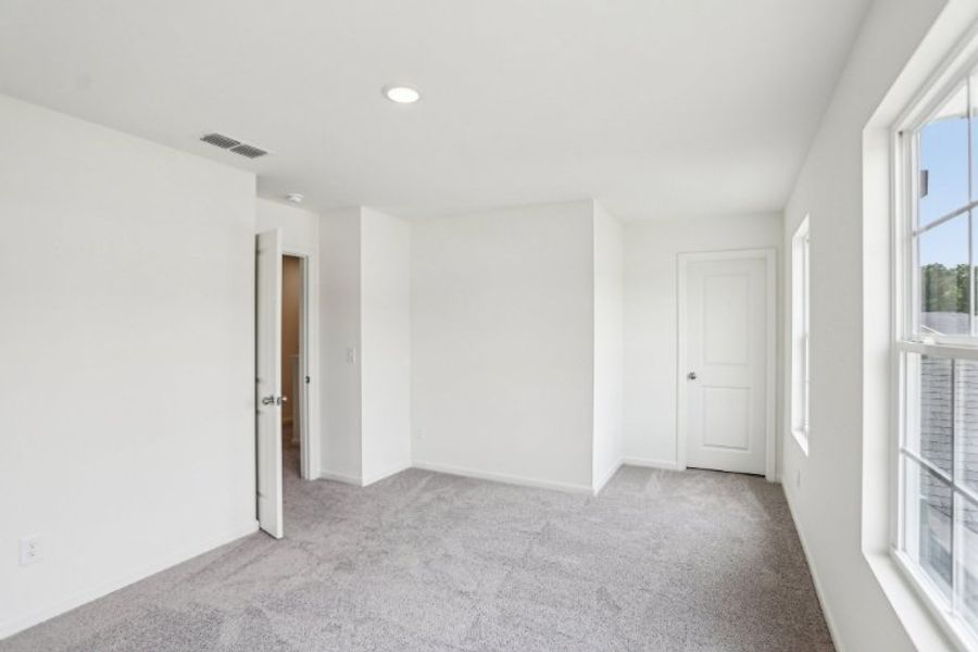 A hallway with white doors.