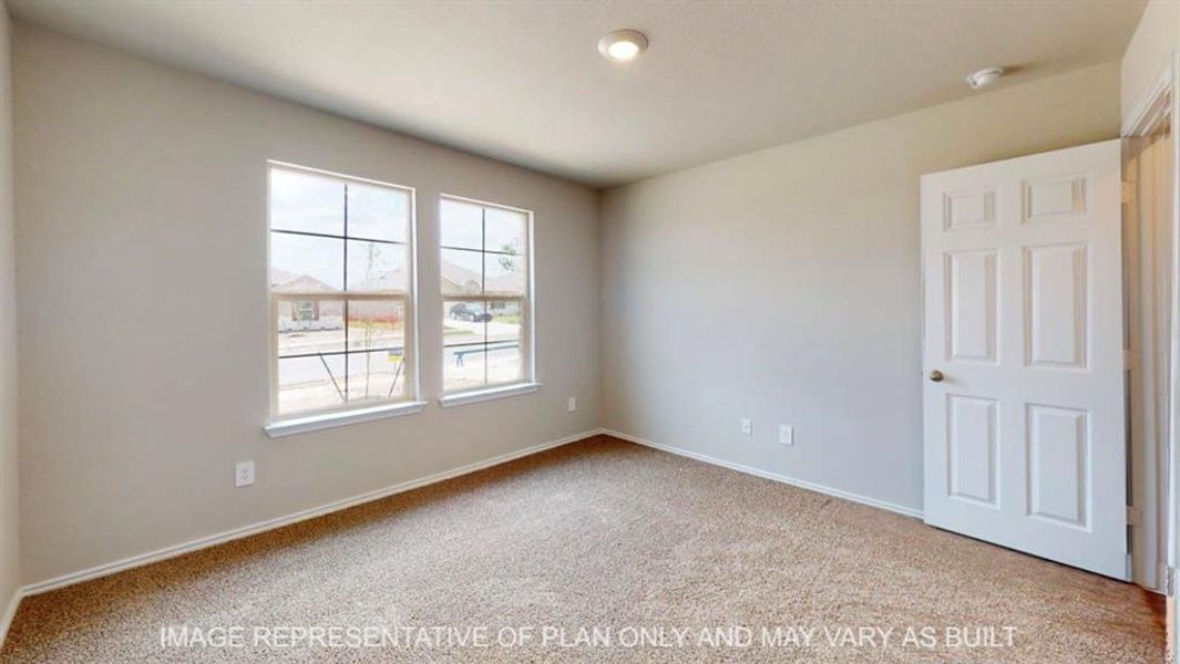 Bright interior room featuring a six-panel door, neutral wall paint, and recessed ceiling lighting