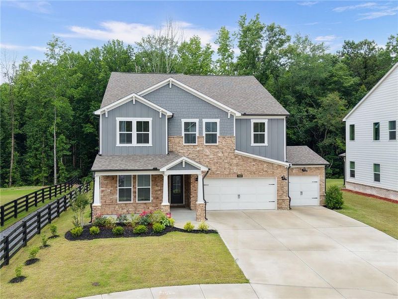 Front exterior of a new home in Hillside Manor, Powder Springs, GA, highlighting curb appeal (Image 28). Front exterior of a new home in Hillside Manor, Powder Springs, GA, highlighting curb appeal (Image 28).