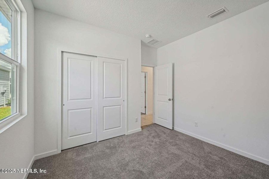 Spacious, unfurnished interior of a new home in Lakes at Bella Lago - Signature Series, Green Cove Springs (Image 24).