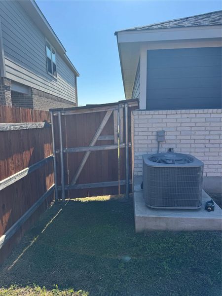 Exterior view of a gate and a fenced backyard