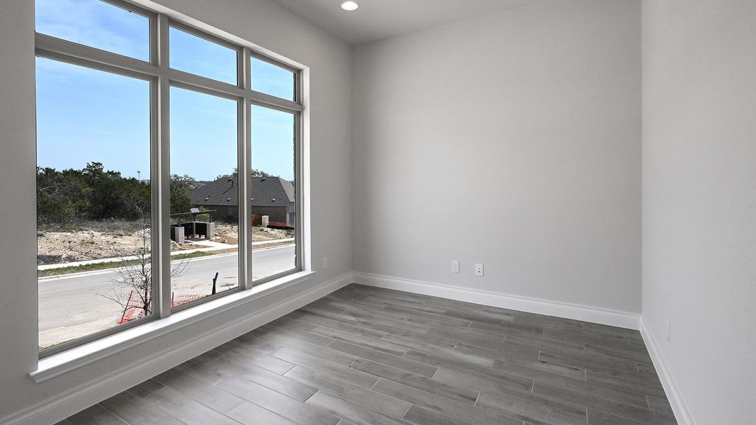 Spare room featuring recessed lighting, baseboards, a healthy amount of sunlight, and dark wood finished floors Spare room featuring recessed lighting, baseboards, a healthy amount of sunlight, and dark wood finished floors