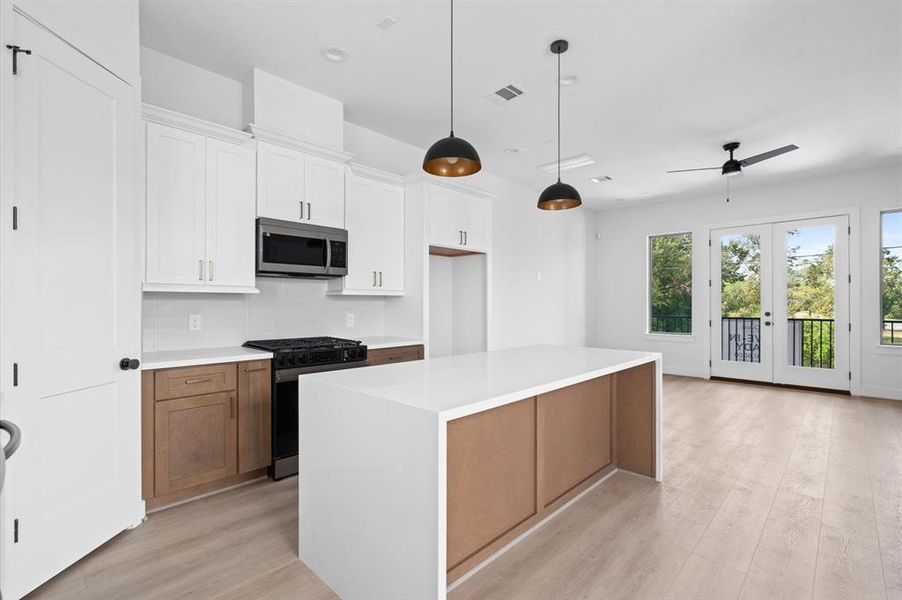 Gorgeous waterfall-edge island and an abundance of cabinetry space.