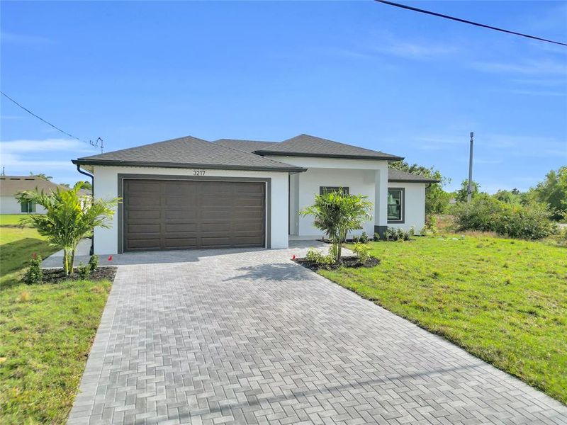 Front exterior of a new home in , Lehigh Acres, FL, highlighting curb appeal (Image 21). Front exterior of a new home in , Lehigh Acres, FL, highlighting curb appeal (Image 21).