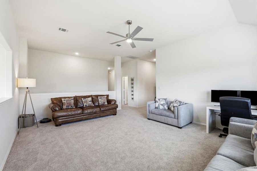 Spacious carpeted bonus room with a ceiling fan, recessed lighting, and a partial wall separating areas