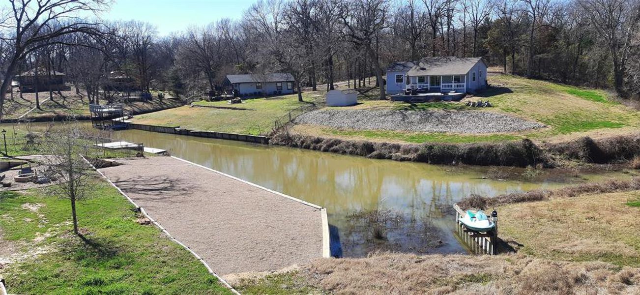 Dock area featuring a lawn and a water view